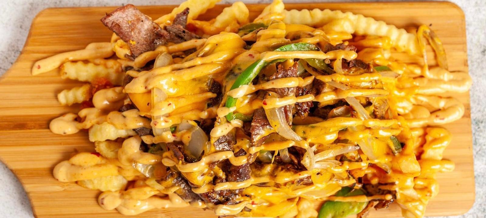 Cheesy loaded fries with beef and sauce drizzle