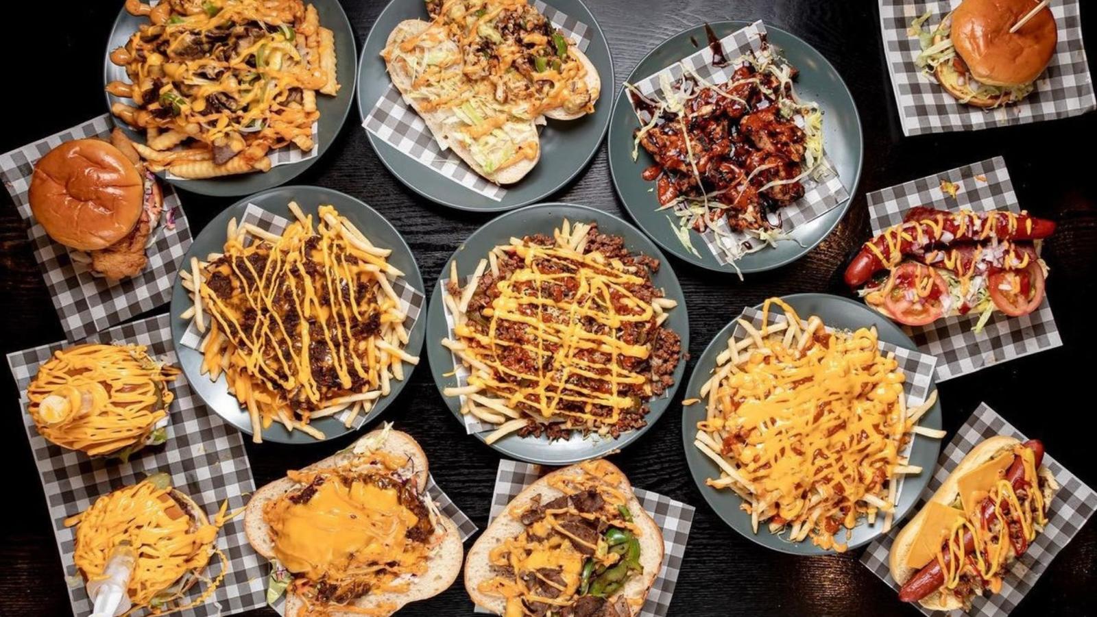 Table spread of burgers, fries and loaded sides
