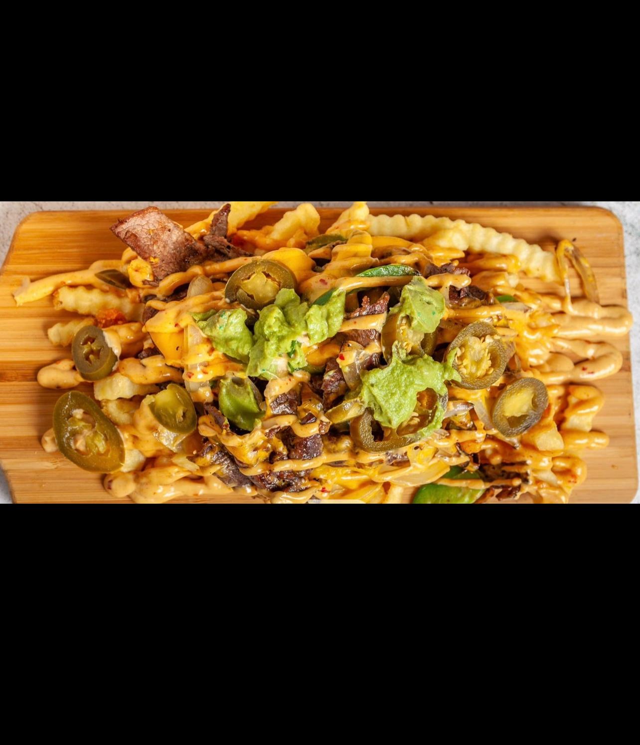 Cheeseburger with fries served on a black plate
